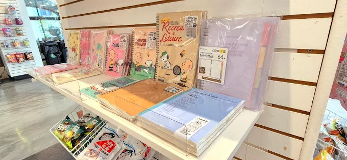 A shelf of Japanese notebooks, pens and stationery